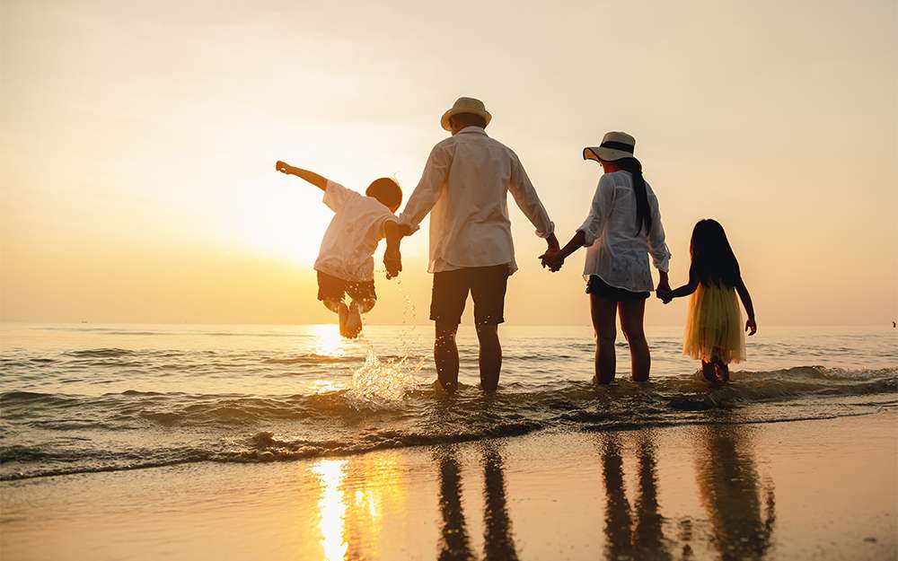Family holding hands at the beach